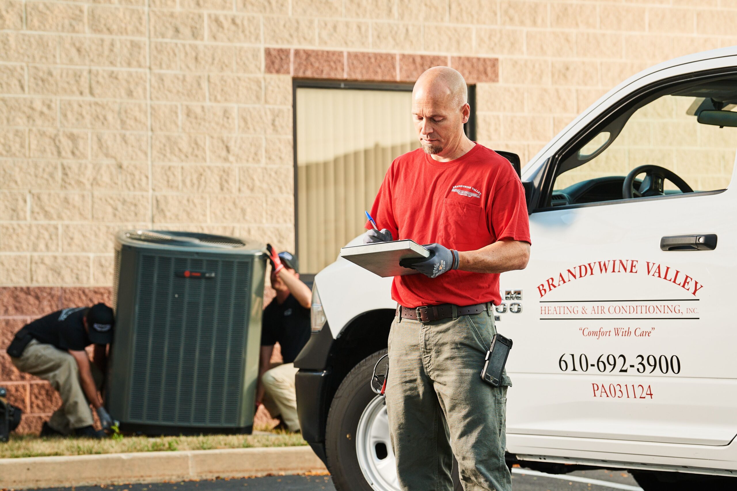 image of a BVHVAC technician working on system