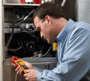 image of a BVHVAC technician working on system