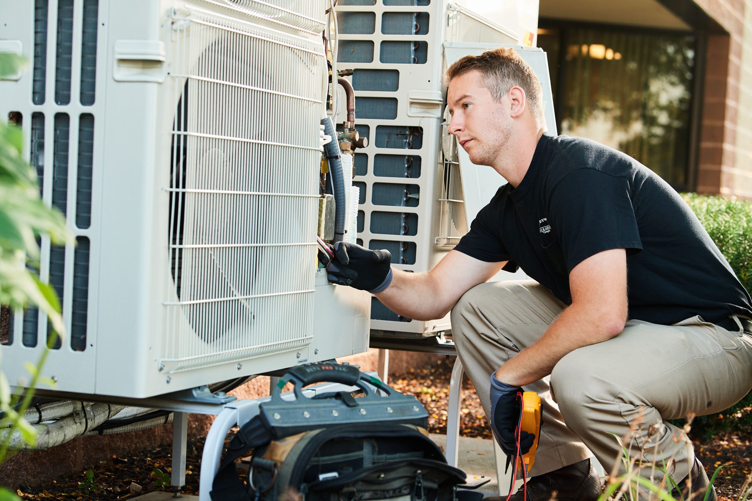 image of a BVHVAC technician working on system