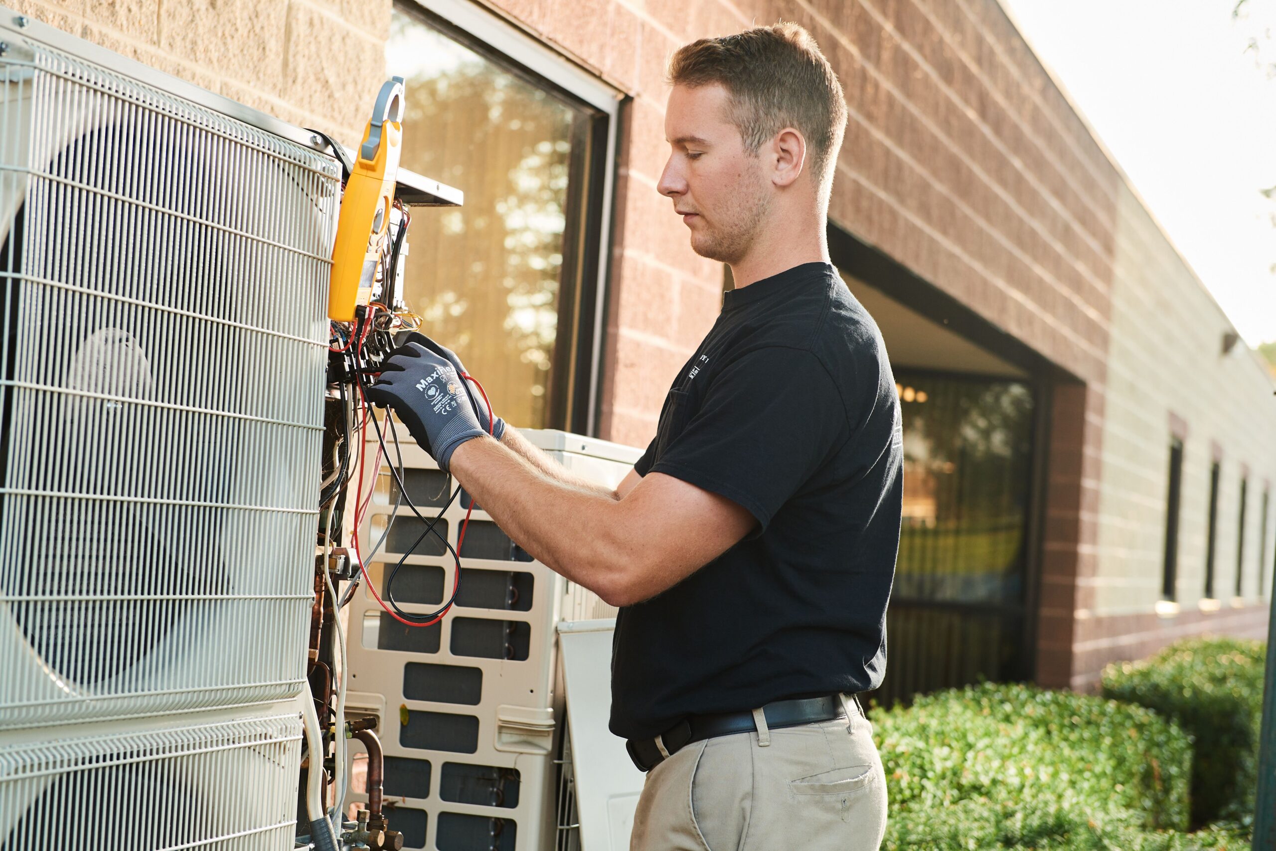 image of a BVHVAC technician working on system