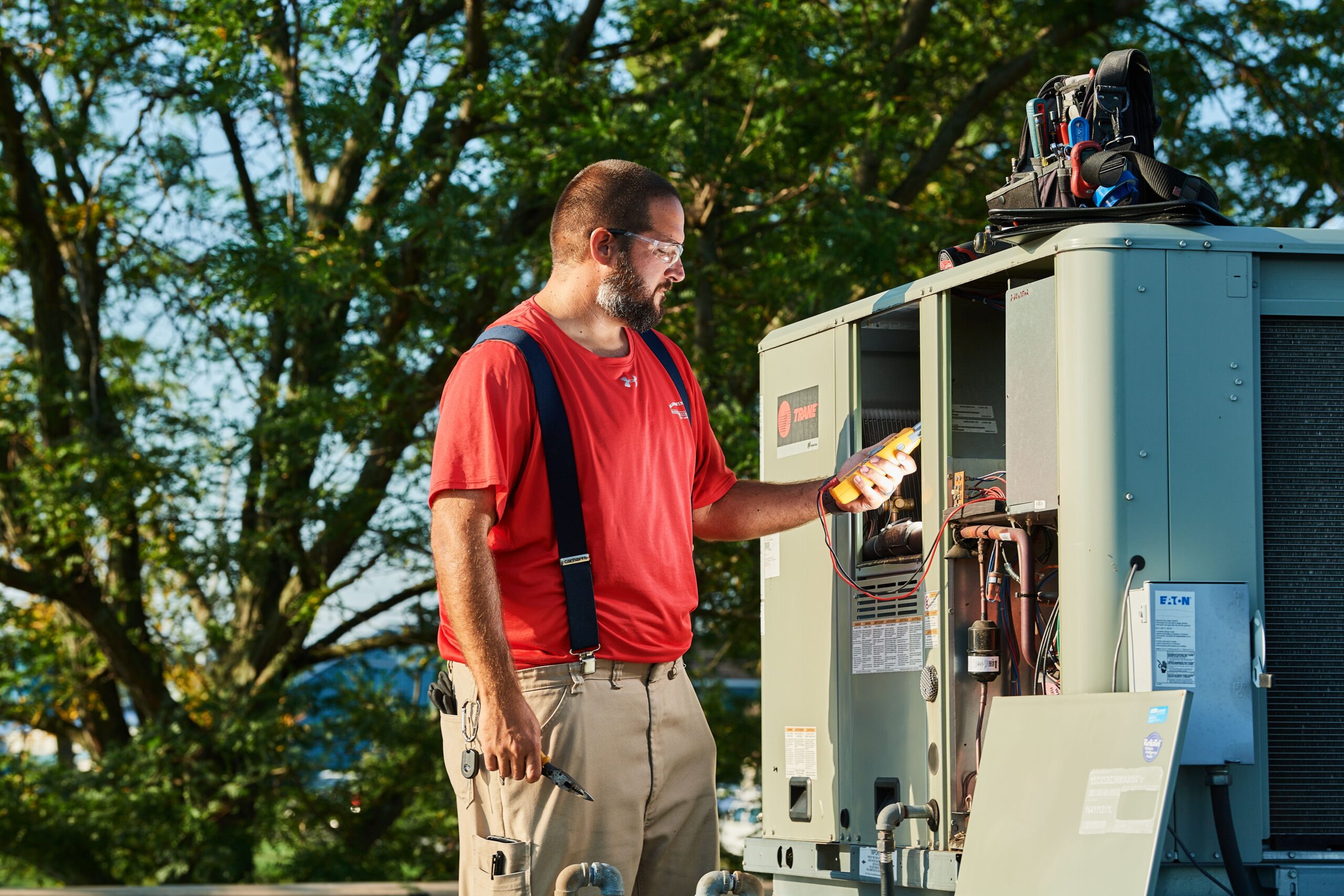 image of a BVHVAC technician working on system