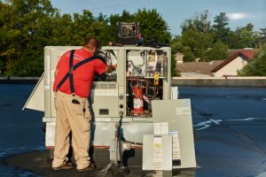 image of a BVHVAC technician working on system
