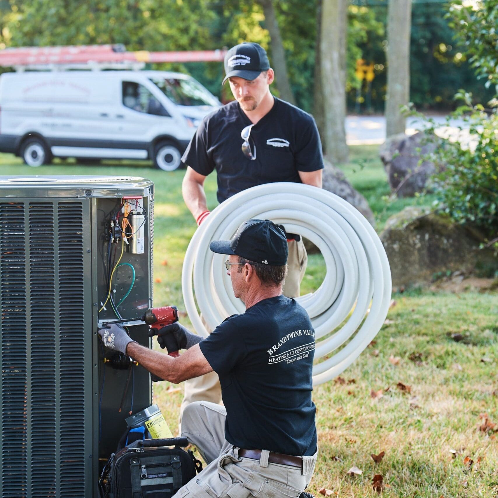 image of a BVHVAC technician working on system