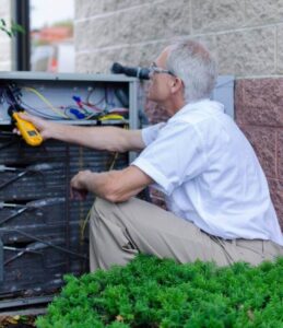 image of a BVHVAC technician working on system